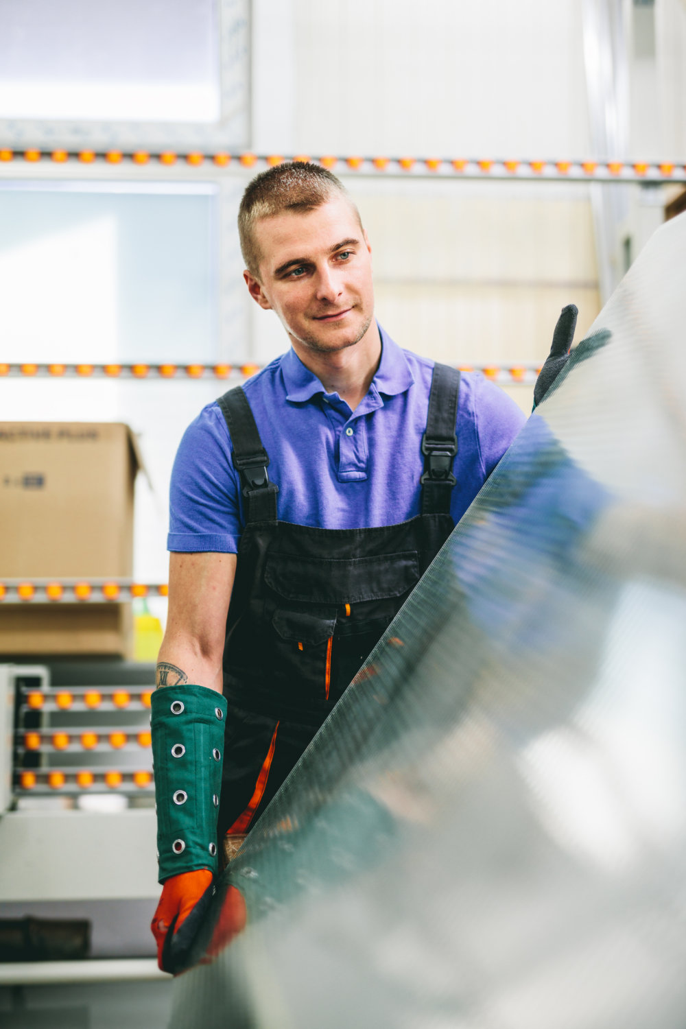 glazier worker portrait with glass in workshop. industry